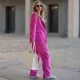 COLOGNE, GERMANY - FEBRUARY 27: Anna Posch wearing Hey Marly bag and sneaker, matching pink suit and black shades on February 27, 2022 in Cologne, Germany. (Photo by Jeremy Moeller/Getty Images)