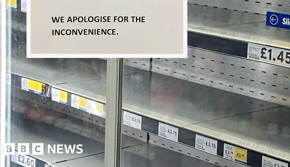 A supermarket fridge cabinet is empty. The shelves display the names of the items and prices which should be on them. A sign reads: 'Customer Notice. Due to the extreme temperatures some of our refrigeration and freezer units have broken down. Stock from these sections is unavailable at present. We apologise for the inconvenience.'