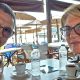Karovic Ljubisa and his wife Svetlana Grković, smiling for a photo in a bar which appears to be at a holiday resort