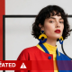 An AI-altered image generated using Muse Image of a woman against a Bauhaus art background and wearing red blue and yellow, with black curly hair