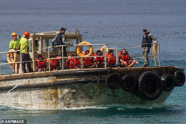 A boat carrying a dozen people, believed to be Chinese asylum seekers, has been intercepted off Far North Queensland (Pictured, asylum seekers arrive at Christmas Island in 2013)