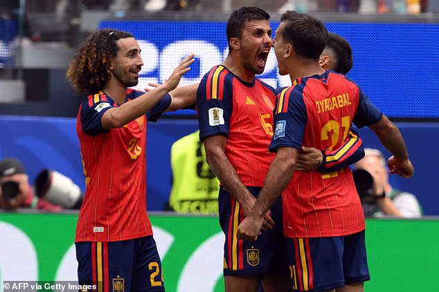 Spain's players Marc Cucurella and Rodri celebrate with goalscorer Mikel Oyarzabal