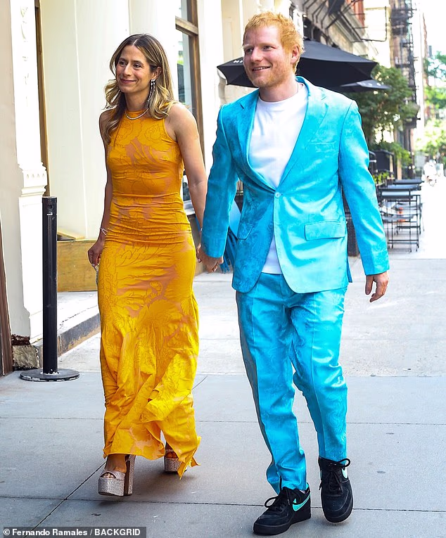 Clashing colors! Ed Sheeran stood out in a bright turquoise silk suit with a paisley pattern. The singer wore a white T-shirt underneath and accessorized with black Nike sneakers, including a matching turquoise 'swoosh' on the side. His wife, Cherry Seaborn, opted for a bright yellow, silky, curve-hugging gown that also appeared to have a paisley pattern. She paired the high-neck dress with bedazzled sky-high heels, a diamond necklace and dangling diamond earrings