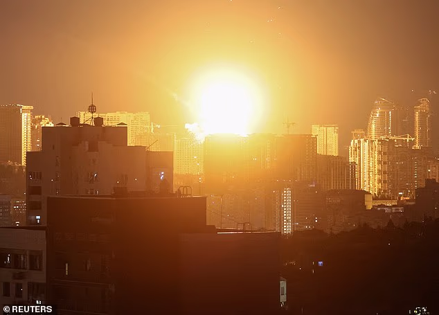 An explosion lights up the sky over Kyiv early yesterday as Russian missiles targeted the Ukrainian capital city. The West is next MPs were told today and Britain is vulnerable.