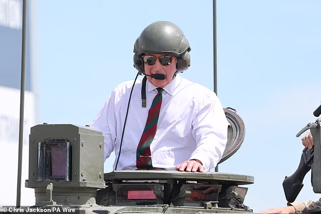 The King swapped regal finery for a crew guard helmet as he got to ride in a Challenger 2 tank today