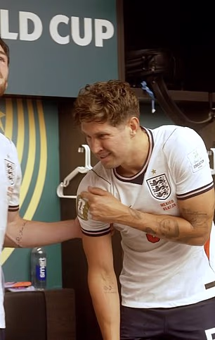 John Stones winced as he pointed to his shoulder