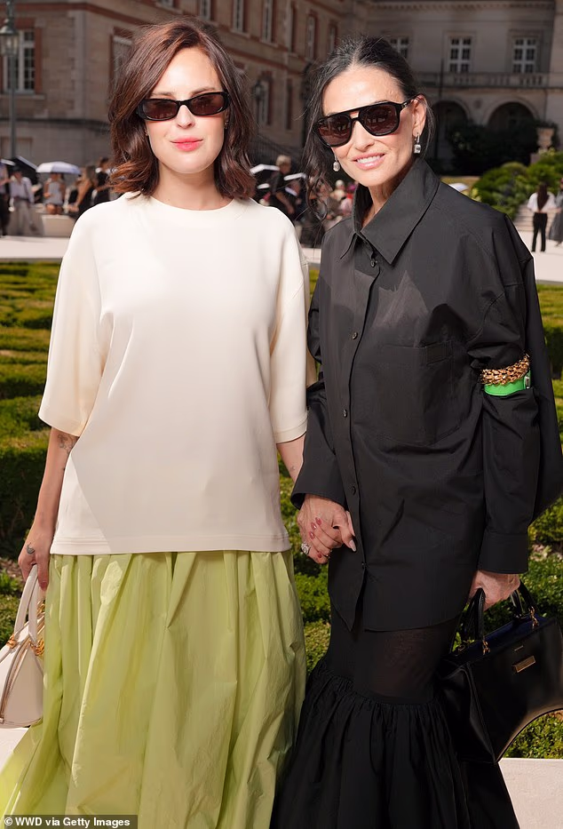 Demi Moore and Tallulah Willis, her daughter with Bruce Willis, posed hand in hand at Balenciaga's Paris Couture Week presentation, where they had front-row seats to see Pierpaolo Piccioli's autumn collection