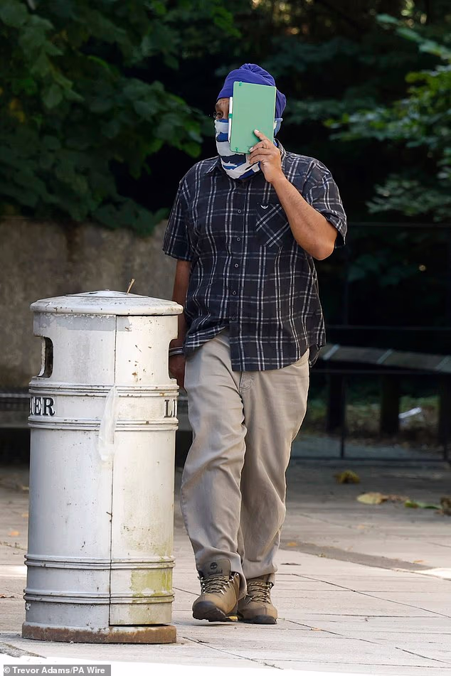Moga Singh tried to cover his face from photographers as he arrived at Southampton Magistrates' Court today