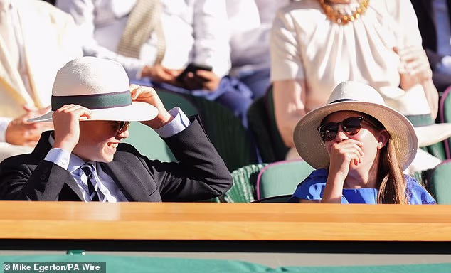 Prince George and Princess Charlotte wear hats during the heatwave at Wimbledon today
