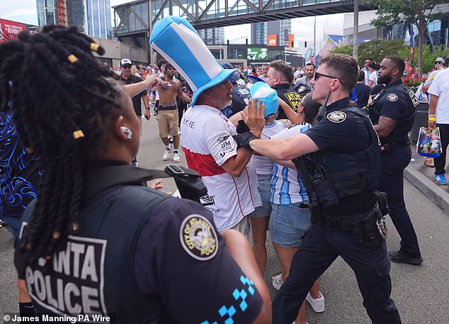 Police officers intervene and speak to fans in Atlanta as they try to keep the peace following Argentina's semi-final victory