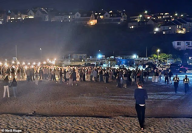 Groups of teenagers gather together on Polzeath beach in Cornwall after breaking up for their summer holidays