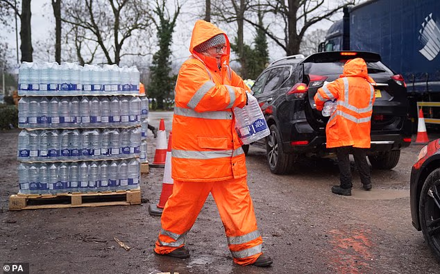 South East Water staff hand out bottled water at a water station in Kent on January 13, 2026