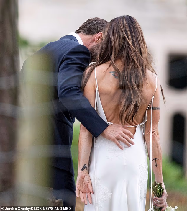 Mel C was a picture of wedded bliss on Saturday as she shared an intimate moment with new husband Chris Dingwall after saying 'I do' in front of their loved ones