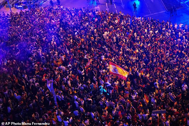 Spanish fans celebrate in central Madrid after Spain defeated Argentina in the World Cup final soccer match in East Rutherford, N.J., near New York, Sunday, July 19