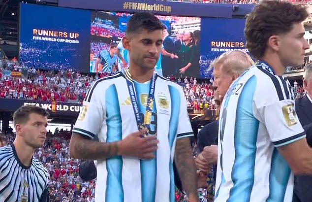 Argentina and Tottenham defender Cristian Romero SNUBS Donald Trump after collecting World Cup runners-up medal
