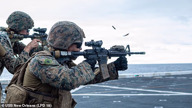 American Marines conduct a live fire evolution on the flight deck of the San Antonio-class amphibious transport dock ship USS New Orleans on February 11