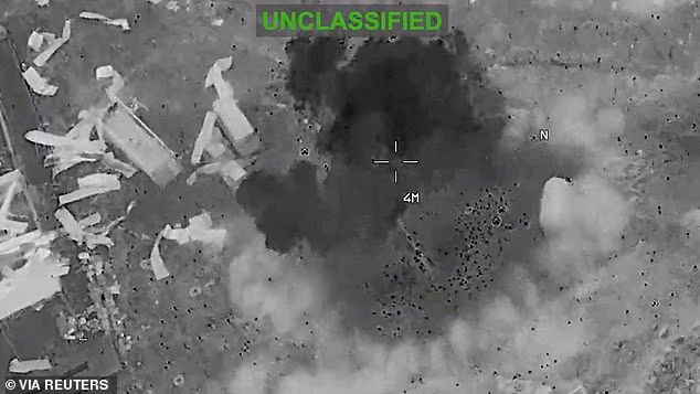Scattered debris and smoke, at an unknown location, during what CENTCOM says are strikes on Iran