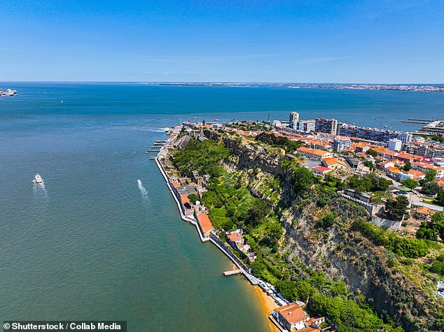 A toddler has died after reportedly being left inside a nursery minibus in Almada (pictured), Portugal, for an estimated seven hours in scorching temperatures