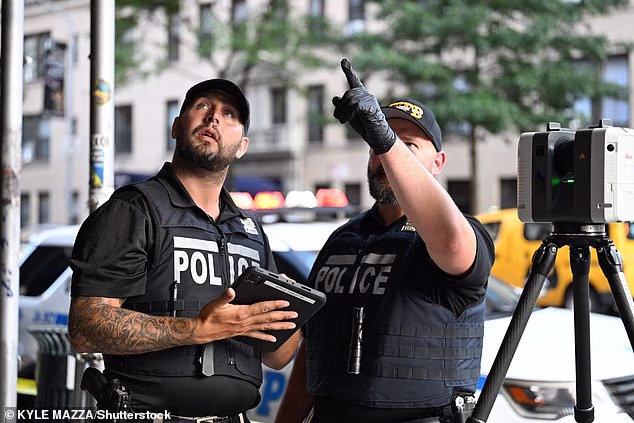 New York City police are pictured responding to the scene of the stabbing attack in New York City's Upper West Side on Thursday