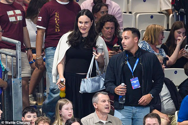 Holly Ramsay was spotted taking her seat in the stands to watch her husband Adam compete in his 100m breaststroke heat at the Commonwealth Games