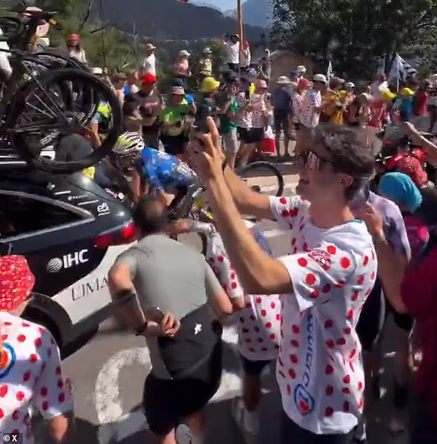 Einer Rubio collides head-first with the UAE Team Emirates-XRG car after it stops abruptly to avoid hitting a spectator that had fallen into its path