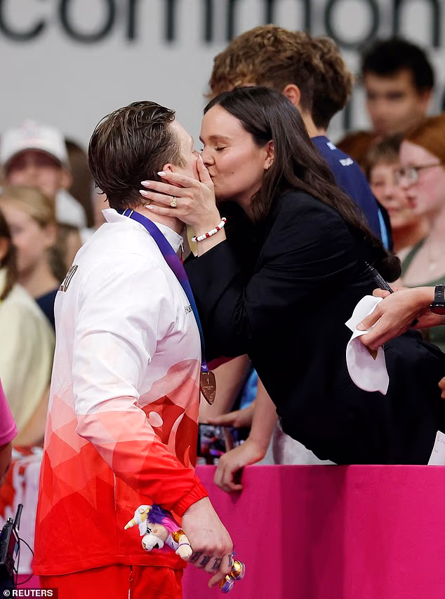 Adam Ramsay-Peaty  kissed pregnant wife Holly as he missed out on his 33rd major gold medal as he finished in third place in 100m breaststroke final at Commonwealth Games on Saturday