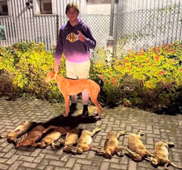 A man posing with a dog and hare corpses on the 'East Midlands Hare Coursing' Facebook group