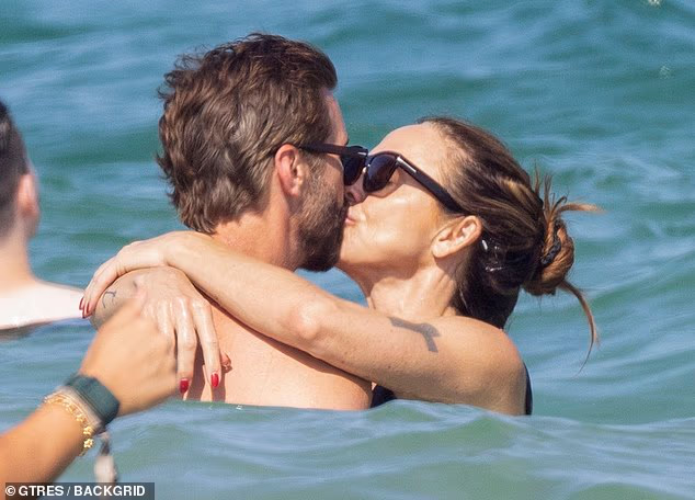Mel C and her new husband Chris Dingwall couldn't keep their hands off each other as they passionately kissed in the sea on their honeymoon in Ibiza