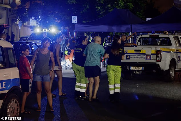 Emergency workers assist a resident following a magnitude 4.7 earthquake in Pozzuoli
