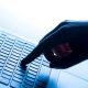 A hand with index finger outstretched pressing a key in the middle of a laptop keyboard.
