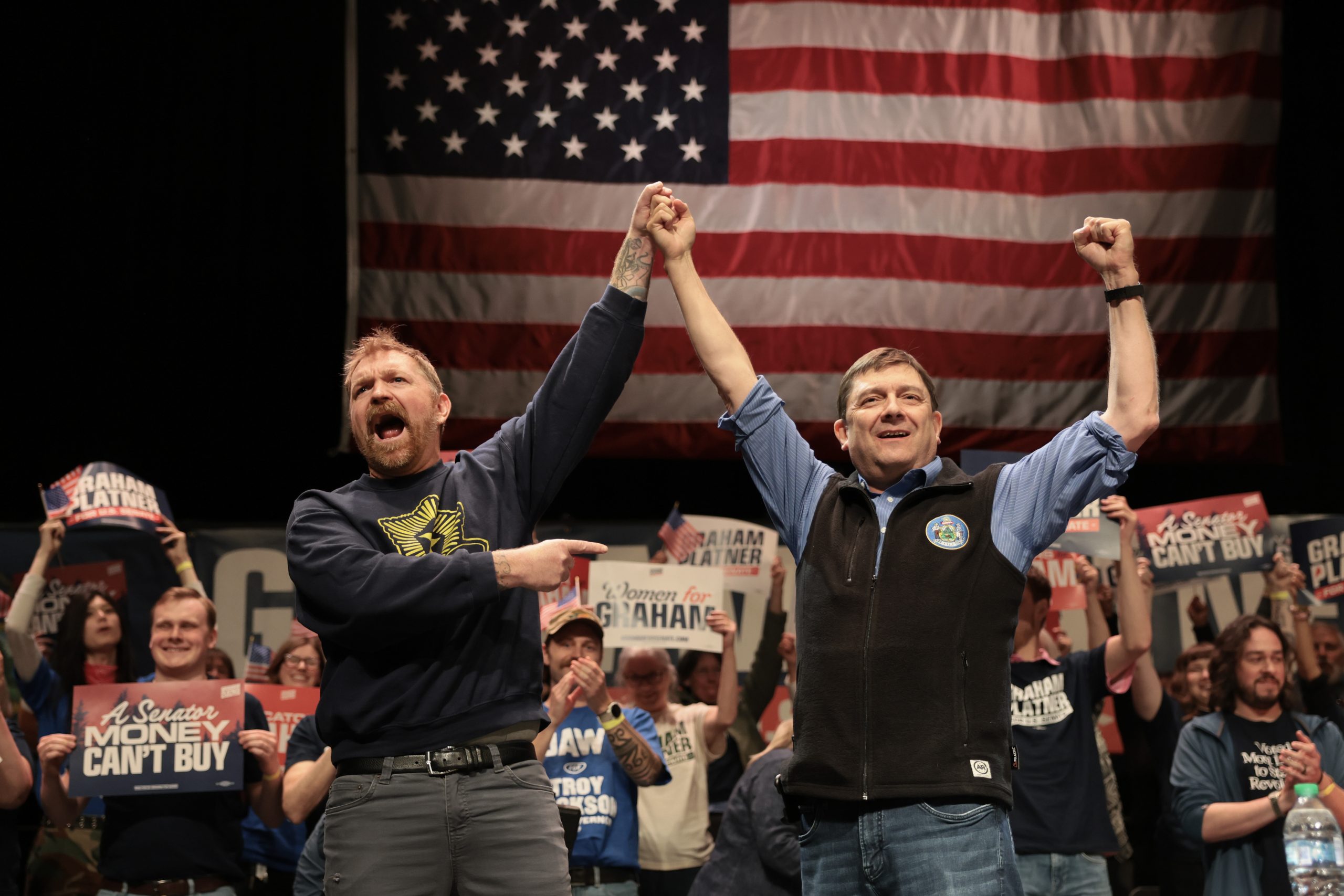 Graham Platner and Troy Jackson stand together during a “Fighting Oligarchy” tour stop on May 24, 2026, in Orono, Maine.