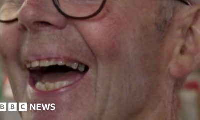 Patrick Meredith, he's a white man with glasses and grey hair. He's mid laugh, looking just away from the view of the camera.
