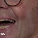 Patrick Meredith, he's a white man with glasses and grey hair. He's mid laugh, looking just away from the view of the camera.