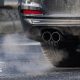 A car's exhaust pipe is in view with some of the car also shown.