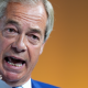 Reform UK leader Nigel Farage speaking during a conference at Olympia London in June 2026.