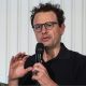 Anthropic chief executive Dario Amodei speaks through a microphone during a summit