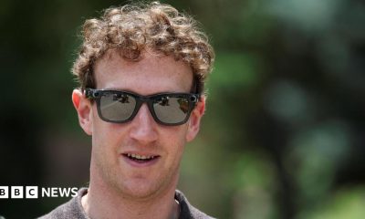 Meta CEO Mark Zuckerberg walking outside wearing a polo-style shirt and a pair of his company's camera-enabled sunglasses.