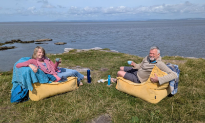 The author (left) having a cup of tea on the edge of a cliff.