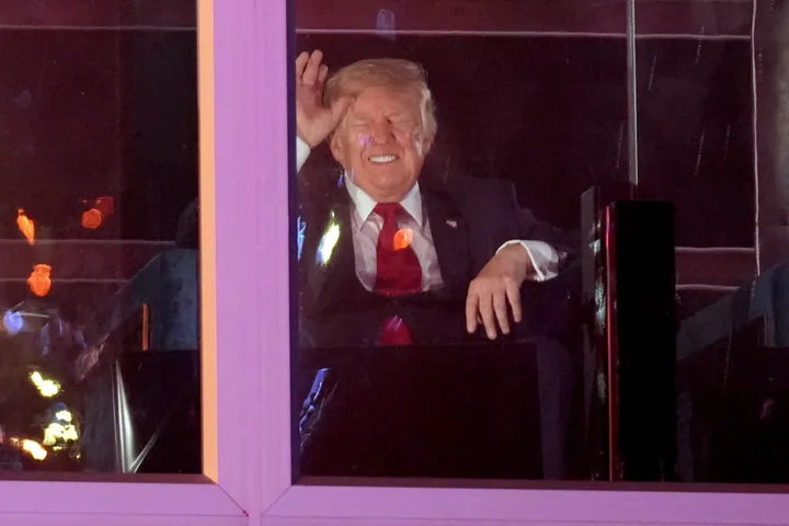 President Trump watches a fireworks show during “Salute to America 250” just past midnight on Saturday. Fourth of July celebrations dragged into the evening after severe weather prompted the evacuation of the National Mall.