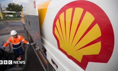 The Shell logo on a new fuel tanker truck as it delivers petrol to a gas station