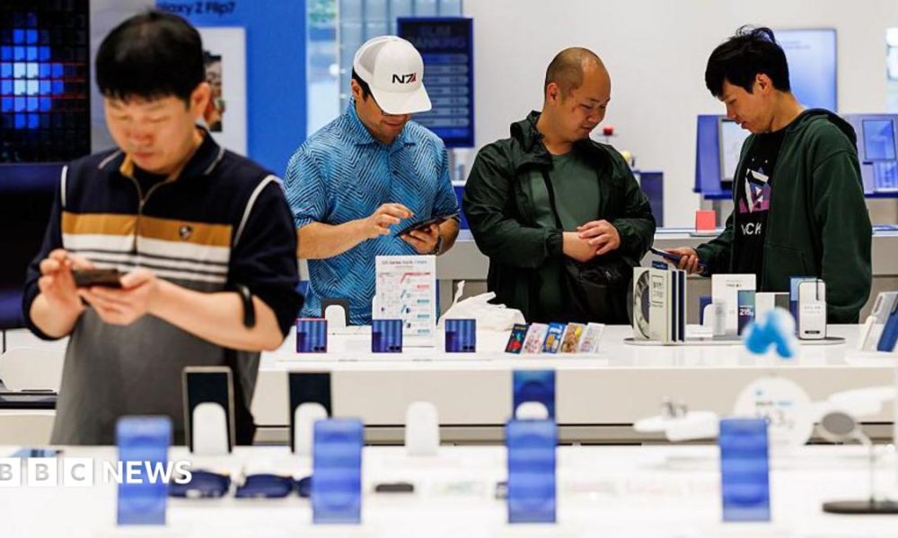 Customers try Samsung smartphones at one of the company's stores in Seoul