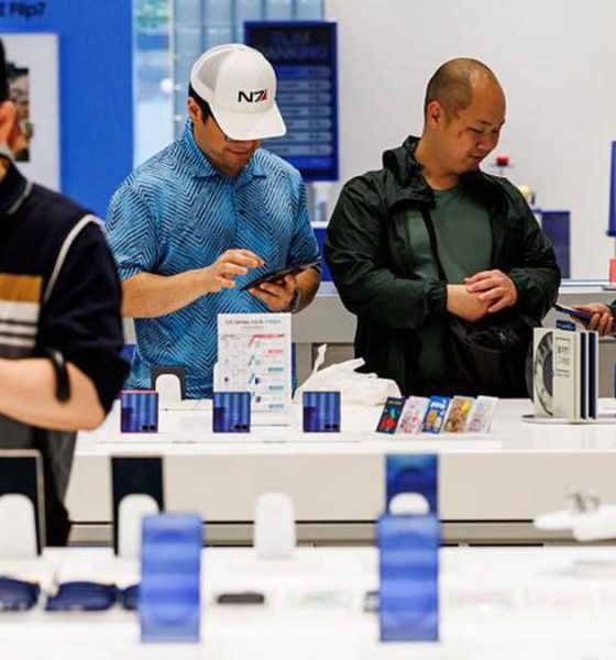 Customers try Samsung smartphones at one of the company's stores in Seoul