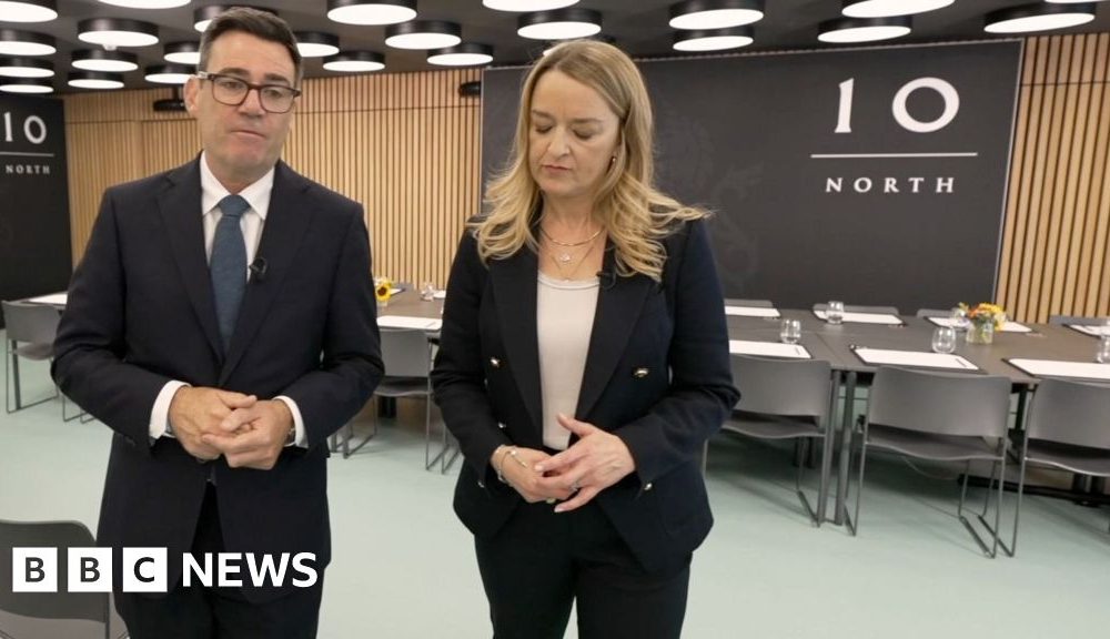Andy Burnham and Laura Kuenssberg walking in an office with '10 North' written on a signbehind them