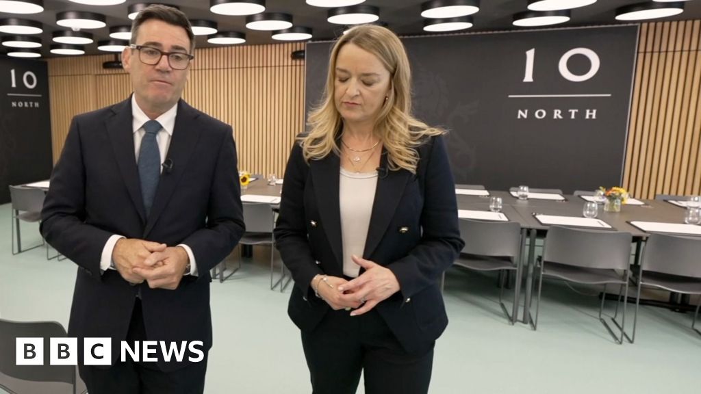 Andy Burnham and Laura Kuenssberg walking in an office with '10 North' written on a signbehind them