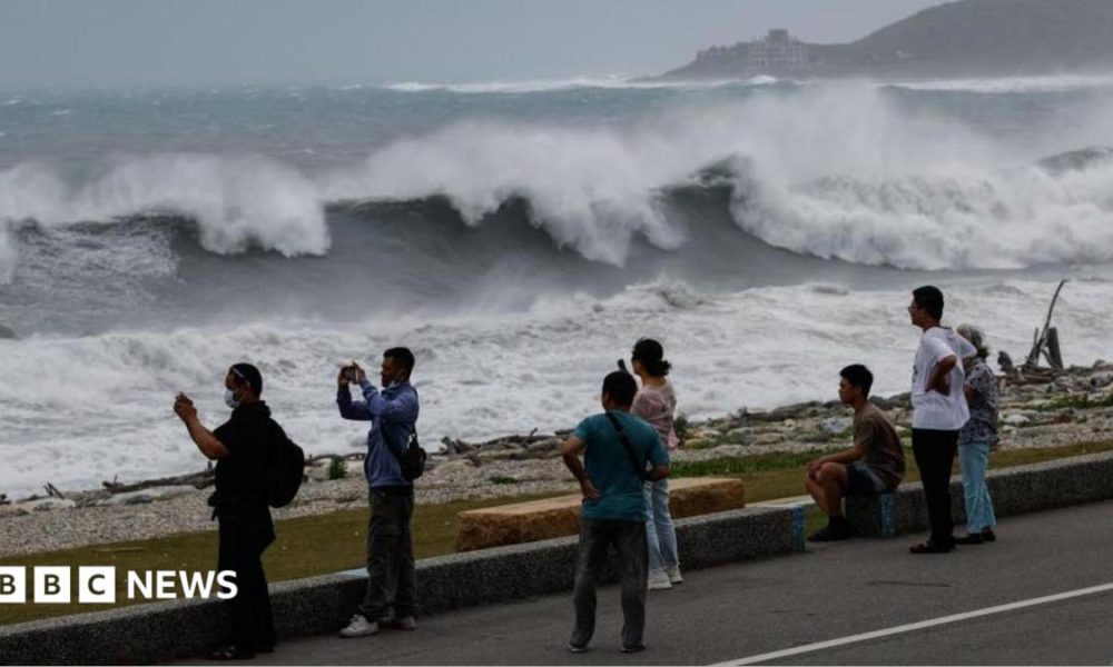 Residents observe huge waves brought by Typhoon Bavi in Hualien city, Taiwan
