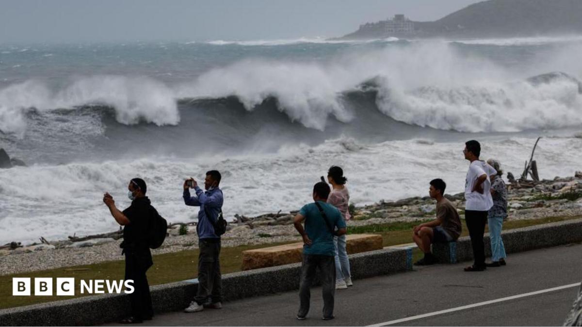 Residents observe huge waves brought by Typhoon Bavi in Hualien city, Taiwan