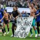 The Argentina players celebrate at full-time with a banner that reads "The Falkland Islands are Argentinian" during the World Cup 2026 semi-final between England and Argentina