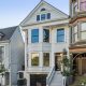 Three homes on a residential street in San Francisco. The three floor homes look clean and well maintained with well-trimmed plants and trees outside.