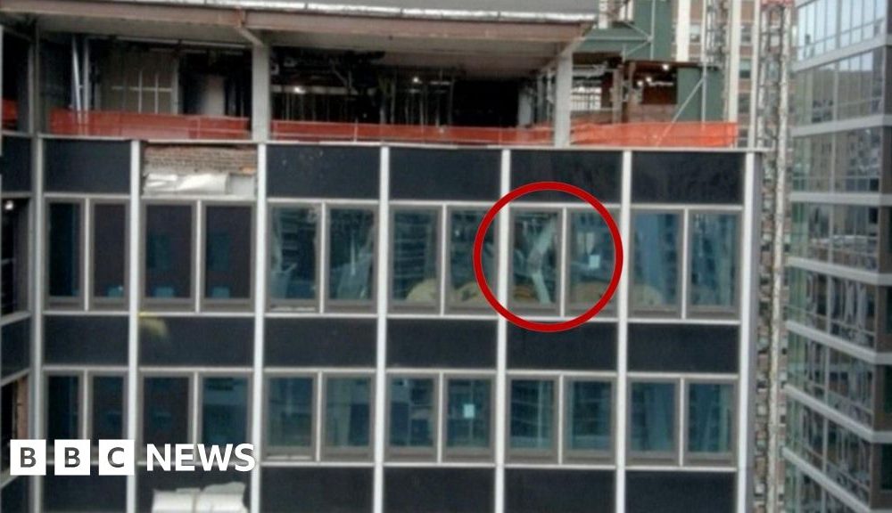 A NYC high-rise building has broken structural beams. In the image, one broken beam is circled in red.