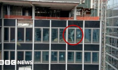 A NYC high-rise building has broken structural beams. In the image, one broken beam is circled in red.